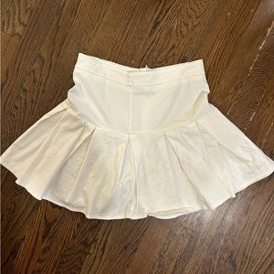 Tilly’s white pleated skirt